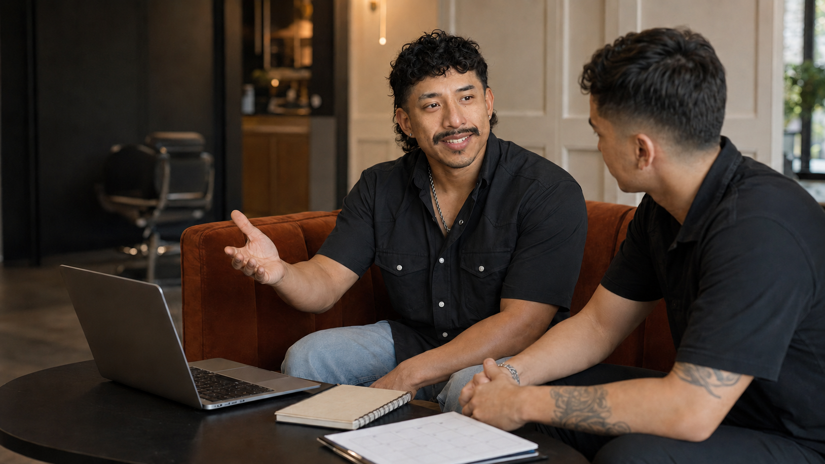 Jorge coaching a barber one-on-one over a laptop